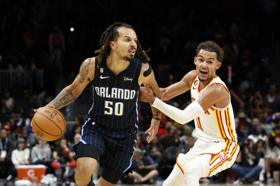 Orlando Magic guard Cole Anthony (50) dribbles around Atlanta Hawks guard Trae Young (11) during the second half of an NBA basketball game Friday, Oct. 21, 2022, in Atlanta. (AP Photo/Butch Dill)