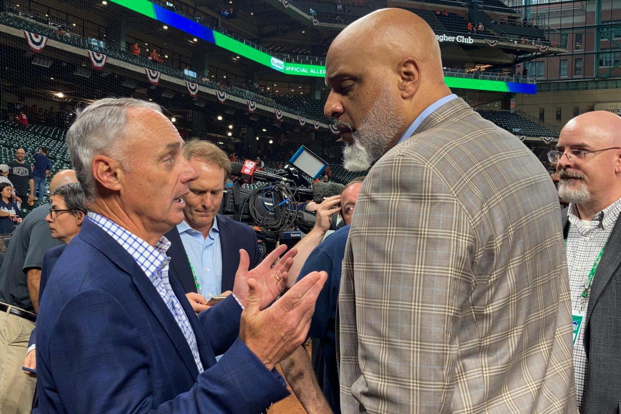 Baseball Commissioner Rob Manfred, left, and Major League Baseball Players Association executive director Tony Clark speak before Game 1 of the World Series in October. A five-year contract between MLB and the players association expires at 10:59 p.m. Central.