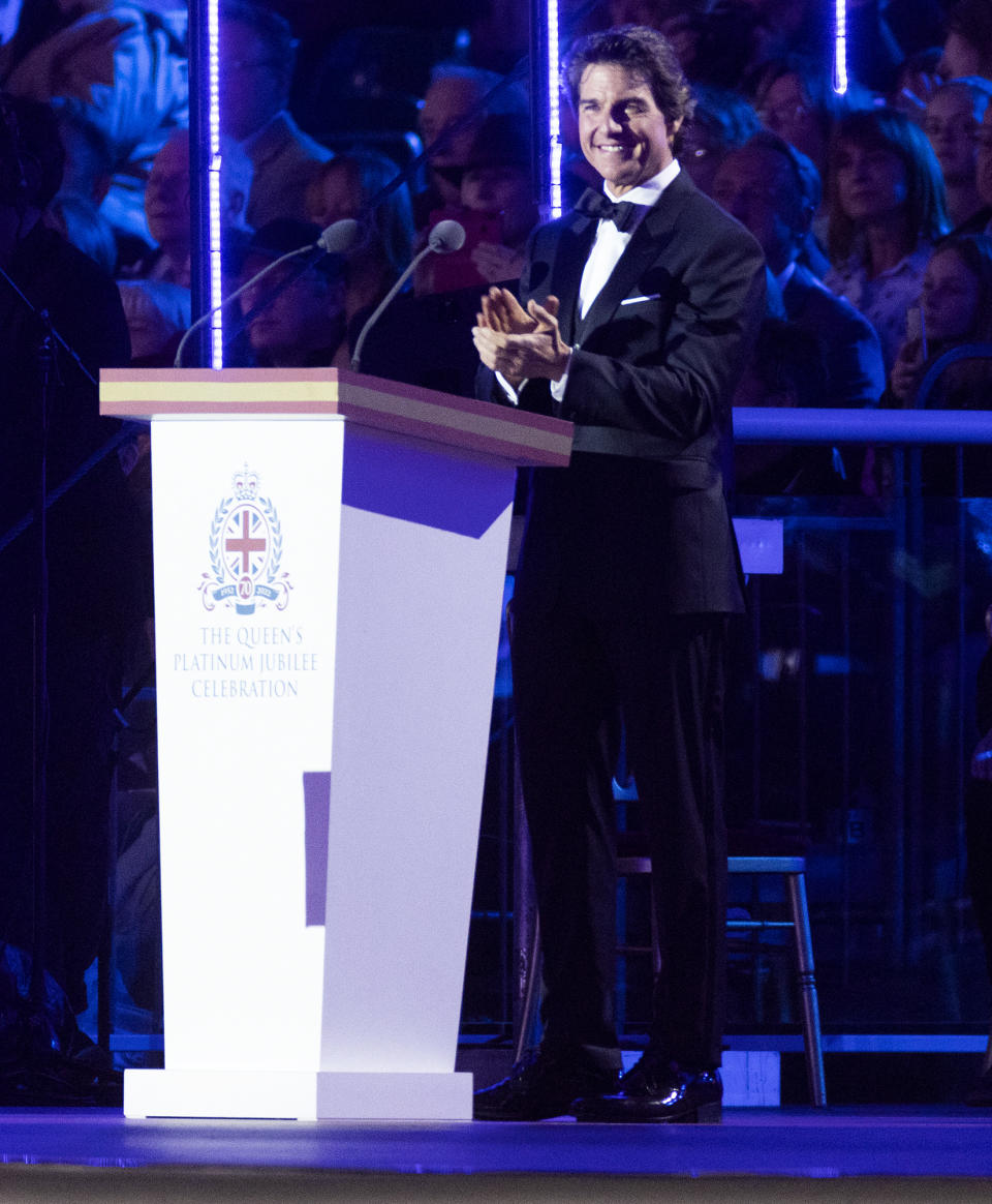 <p>Tom Cruise mans the mic on May 15 at the Queen's Platinum Jubilee Celebration TV show taping at the Windsor Horse Show in England.</p>