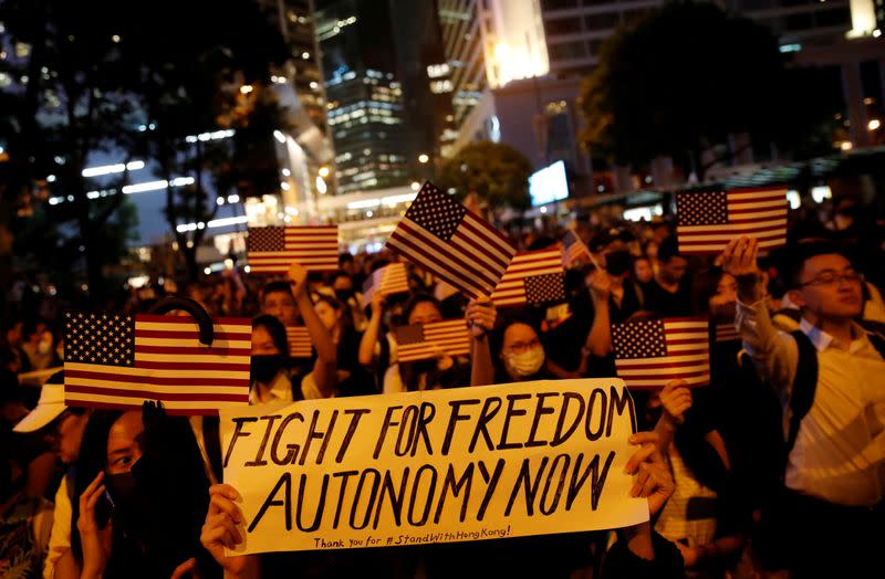 FILE PHOTO: A banner is seen as anti-government demonstrators march in protest against the invocation of the emergency laws in Hong Kong, China,