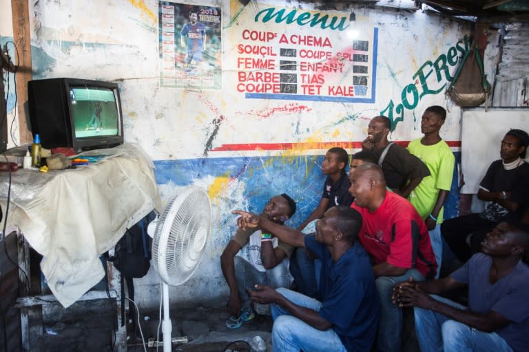 Haitians watch Saturday's World Cup Group Stage match between Argentina and Iceland in a small barber shop in downtown Port-au-Prince