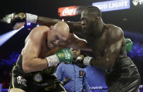 Tyson Fury, left, of England, fights Deontay Wilder during a WBC heavyweight championship boxing match Saturday, Feb. 22, 2020, in Las Vegas. (AP Photo/Isaac Brekken)