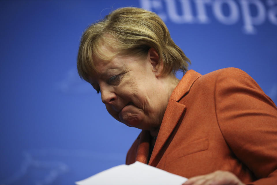 German Chancellor Angela Merkel leaves after addressing a media conference during an EU summit in Brussels, Friday, Dec. 13, 2019. European Union leaders gathered for their year-end summit and discussed climate change funding, the departure of the UK from the bloc and their next 7-year budget. (AP Photo/Francisco Seco)