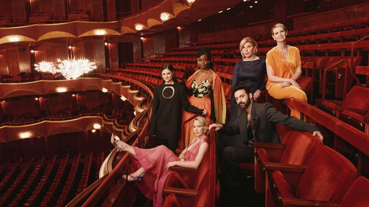 a group of people posing for a photo in a theater