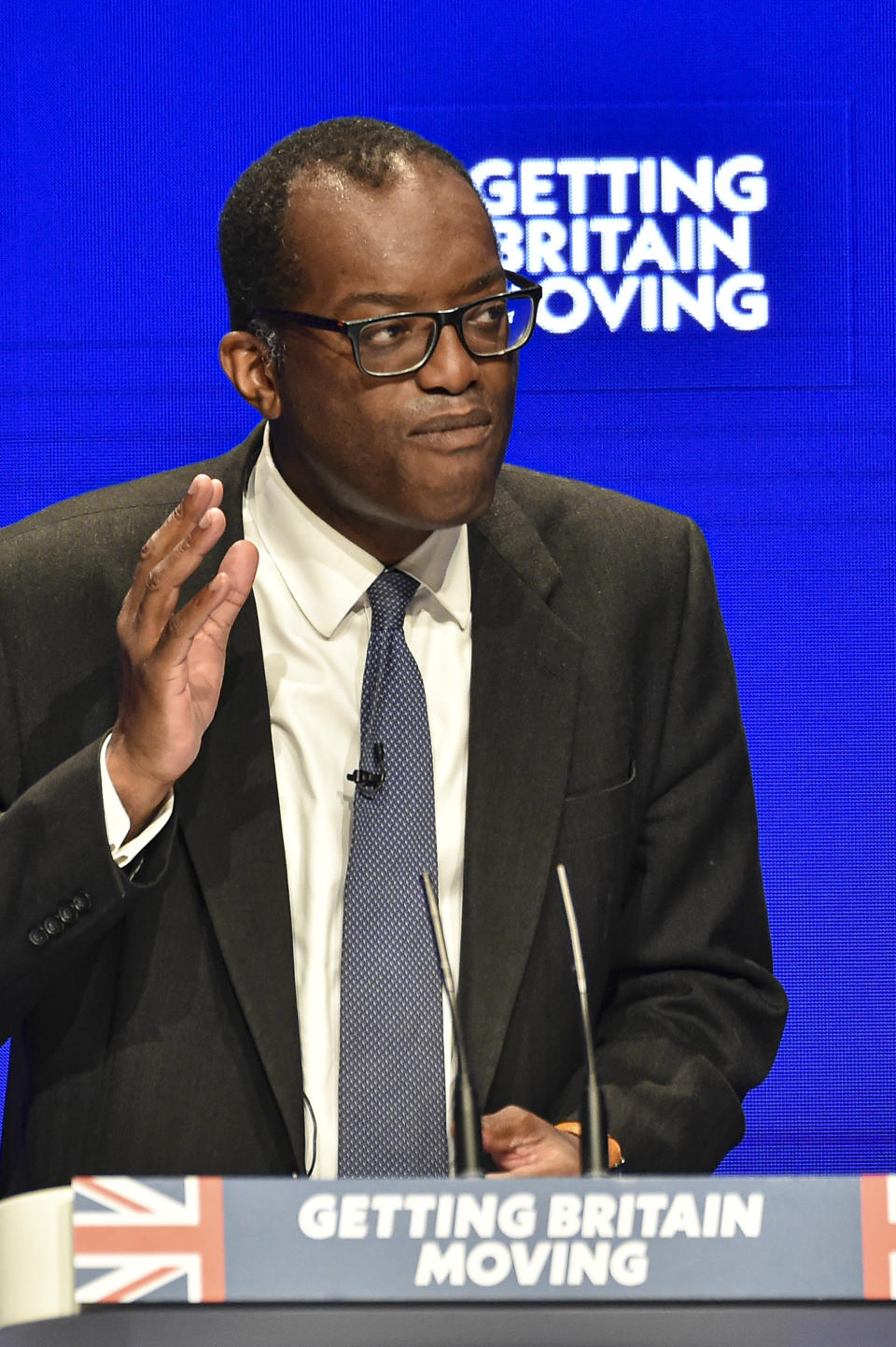 Britain's Chancellor of the Exchequer Kwasi Kwarteng speaks at the Conservative Party conference at the ICC in Birmingham, England, Monday, Oct. 3, 2022. The British government has dropped plans to cut income tax for top earners, part of a package of unfunded cuts that sparked turmoil on financial markets and sent the pound to record lows. (AP Photo/Rui Vieira)