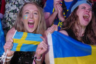 Swedish Eurovision fans in the Fan Zone react as Loreen of Sweden wins Grand Final of the Eurovision Song Contest in Liverpool, England, Saturday, May 13, 2023. (AP Photo/Jon Super)