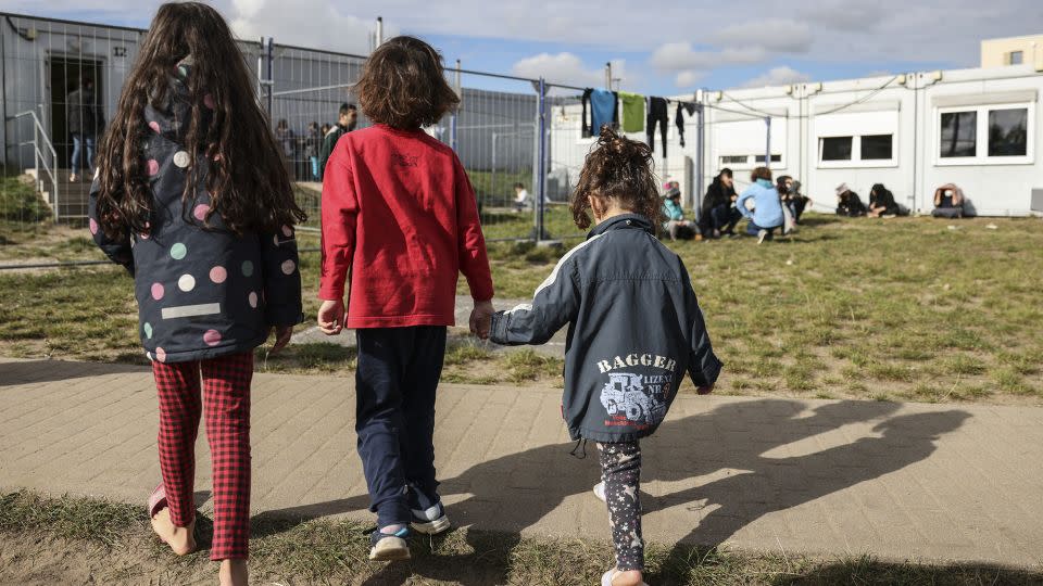 Children walk near a holding facility for irregular migrants on October 06, 2021 in Eisenhuttenstadt, Germany. - Maja Hitij/Getty Images