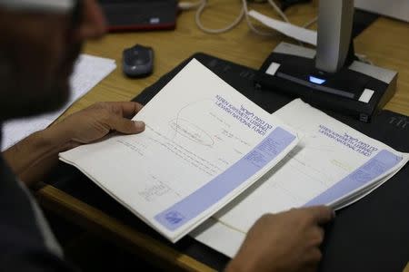 A researcher scans declassified documents for Akevot, an Israeli NGO researching the Israeli-Palestinian conflict, at the Central Zionist Archives in Jerusalem May 10, 2017. Picture taken May 10, 2017. REUTERS/Ronen Zvulun