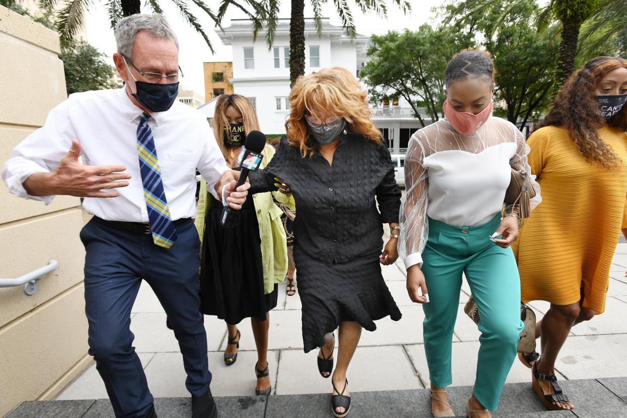 Accompanied by supporters, former U.S Rep. Corrine Brown climbs steps leading to Jacksonville's federal courthouse before a  2020 hearing in 2020 on her motion for "release" from federal supervision after being allowed to leave prison early due to COVID-19 health concerns.