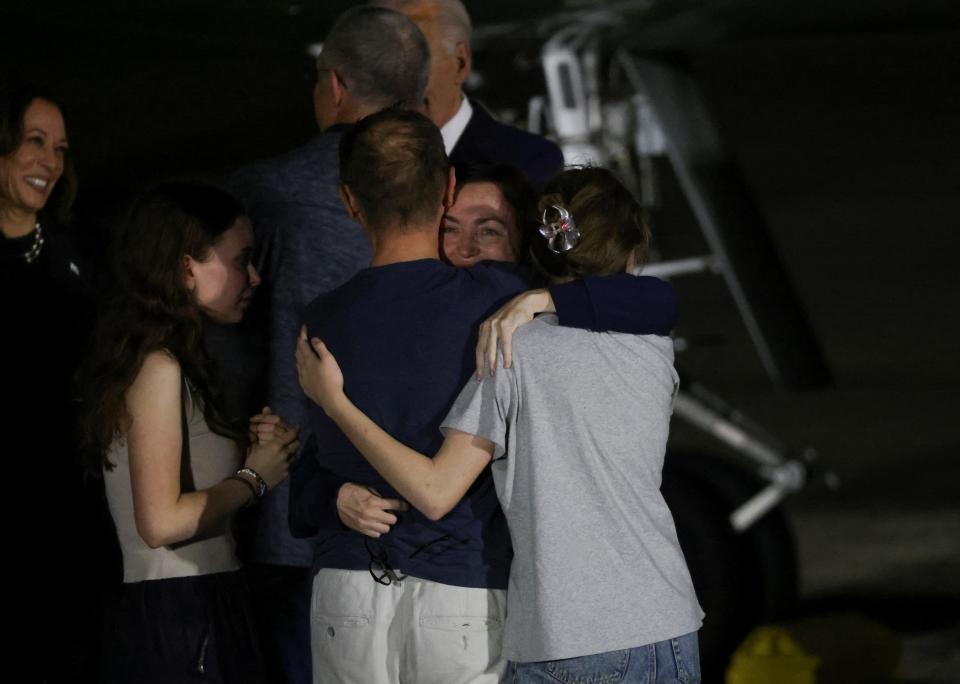 Alsu Kurmasheva hugging her daughters Bibi and Miriam, and her husband Pavel Butorin at Joint Base Andrews