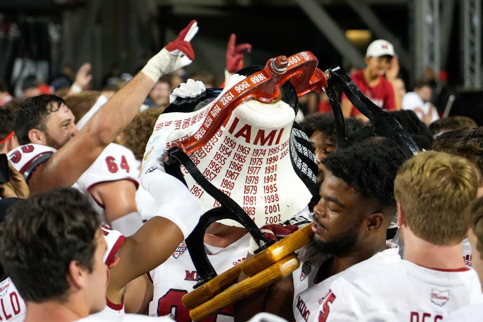 Miami RedHawk player hoist the Victory Bell after knocking off the UC Bearcats at Nippert Stadium last Sept. 16.