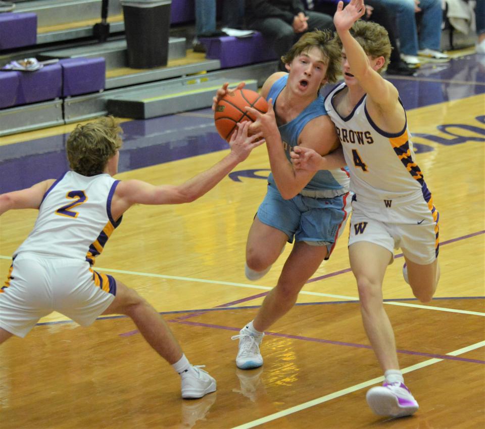 Watertown's Brody Torgerson (2) and Dylon Rawdon (4) attempt to stop the drive of Sioux Falls Lincoln's Eidson Noll during their high school boys basketball game on Tuesday, Jan. 30, 2024 in the Watertown Civic Arena. Lincoln won 61-54.