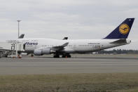 A Lufthansa plane is parked at a gate ahead of a charter flight back to Germany from Christchurch, New Zealand, Monday, April 6, 2020. The German Embassy in Wellington last week said more than 12,000 German tourists had signed up for its repatriation program from New Zealand following the strict monthlong lockdown, which is aimed at preventing more coronavirus infections. The new coronavirus causes mild or moderate symptoms for most people, but for some, especially older adults and people with existing health problems, it can cause more severe illness or death. (AP Photo/Mark Baker)