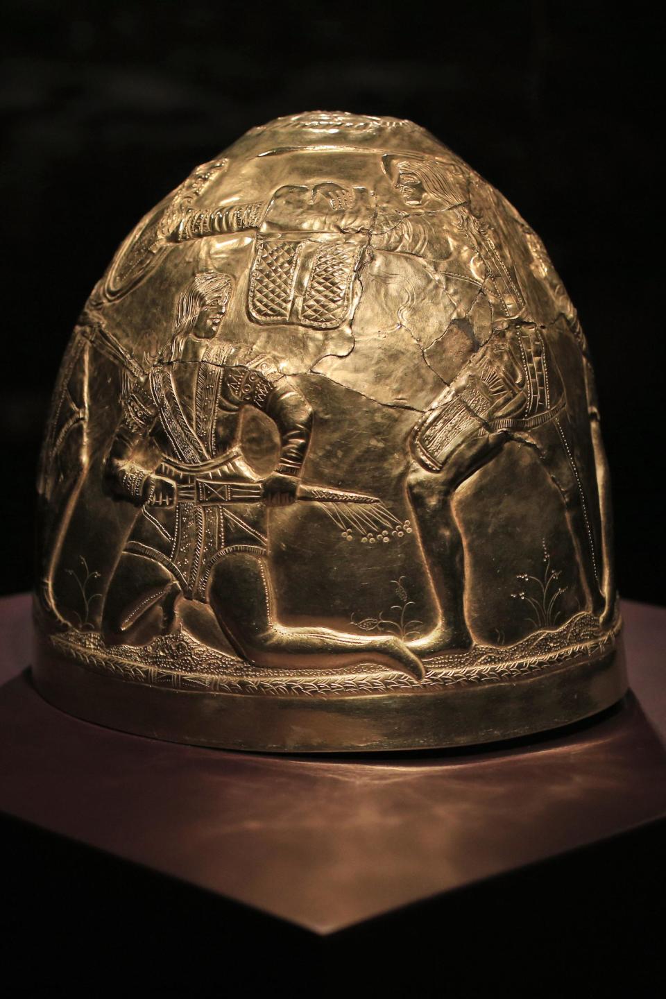 A Scythian gold helmet from the fourth century B.C. is displayed as part of the exhibit called The Crimea - Gold and Secrets of the Black Sea, at Allard Pierson historical museum in Amsterdam Friday April 4, 2014. The museum has gotten more than the bronze swords, golden helmets and precious gems it bargained for as it is unsure where to return the collection after Russia annexed Crimea. (AP Photo/Peter Dejong)