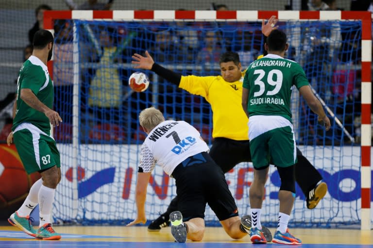 Germany's pivot Patrick Wiencek (Bottom) shoots against Saudi Arabia's goalkeeper Manaf Alsaeed during the 25th IHF Men's World Championship 2017 Group C handball match Germany vs Saudi Arabia on January 17, 2017 at the Kindarena in Rouen