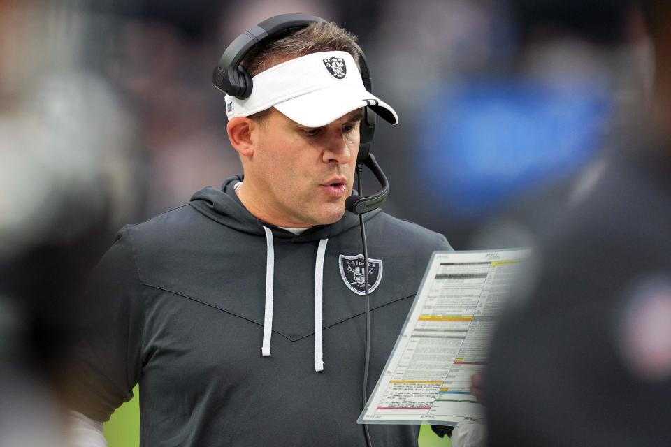 Las Vegas Raiders head coach Josh McDaniels looks at his play sheet in the third quarter against the Arizona Cardinals at Allegiant Stadium on Sept. 18, 2022, in Las Vegas, Nevada.