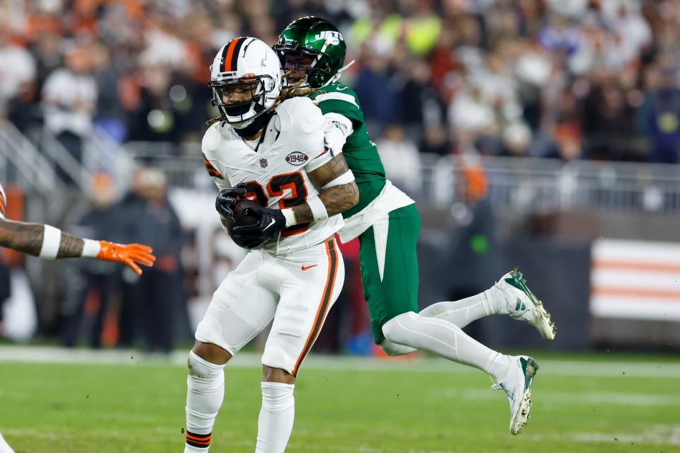 Browns safety Ronnie Hickman intercept a pass for a touchdown intended for New York Jets wide receiver Garrett Wilson during the first half, Thursday, Dec. 28, 2023, in Cleveland.