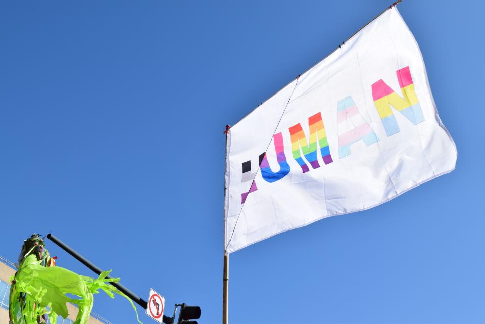A flag that says "human" flies during the 2023 Blue Ridge Pride Precession Sept. 30. Each letter represents a different pride flag.