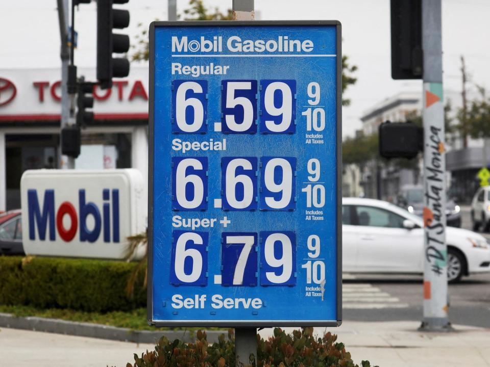 blue gas station sign shows prices above six dollars