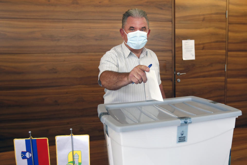 Andrej Vizjak, Slovenia's minister for environment casts his ballot at a polling station in Brezice, Slovenia, Sunday, July 11, 2021. Slovenians voted in a referendum on changes to the country’s waters management law that is seen as a test for the government of right-wing Prime Minister Janez Jansa. Jansa’s government approved the amendments in March but ecologists have pushed through the referendum saying they threaten the environment by paving the way for construction by the sea, rivers and lakes. (AP Photo)