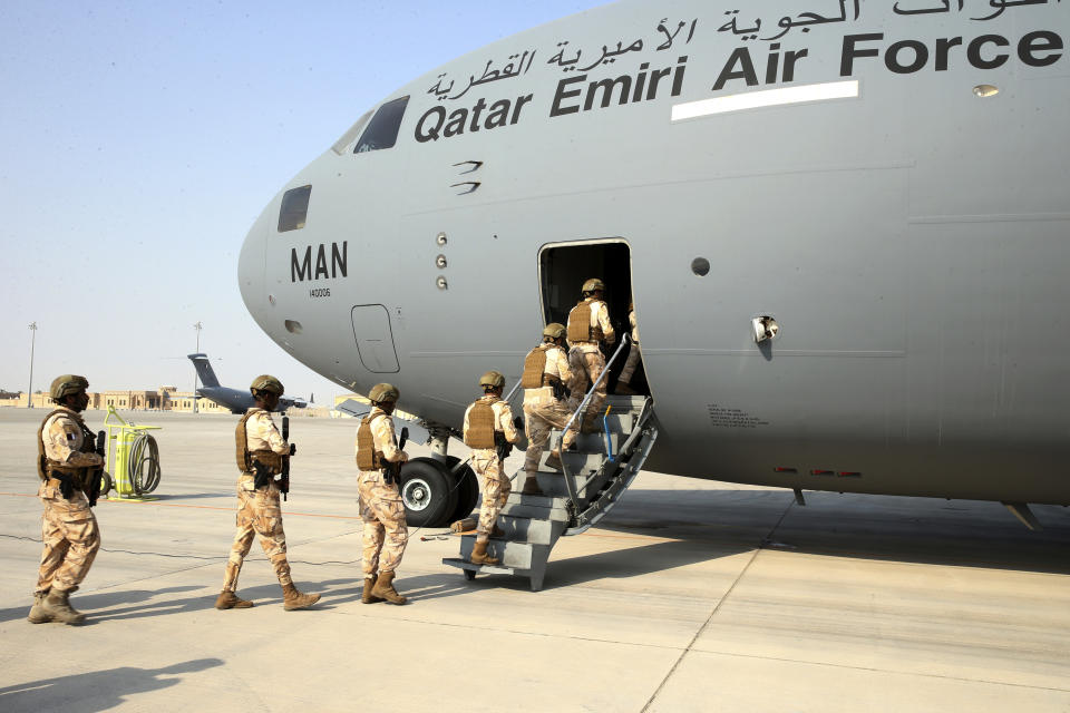 Qatari Air Force airmen board a Qatari transport plane evacuating people, at Hamid Karzai International Airport in Kabul, Afghanistan, August, 18, 2021. Qatar played an out-sized role in U.S. efforts to evacuate tens of thousands of people from Afghanistan. Now the tiny Gulf Arab state is being asked to help shape what is next for Afghanistan because of its ties with both Washington and the Taliban insurgents now in charge in Kabul. (Qatar Government Communications Office via AP)