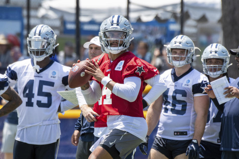 Dallas Cowboys quarterback Dak Prescott, center, passes during practice at the NFL football team's training camp in Oxnard, Calif., Thursday, July 22, 2021. (AP Photo/Michael Owen Baker)