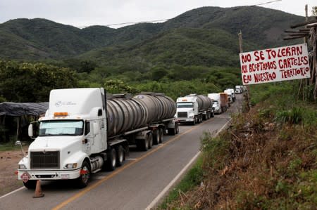 A general view shows cargo trucks queuing to cross a checkpoint of the Community Police in the municipality of San Diego Xayakalan