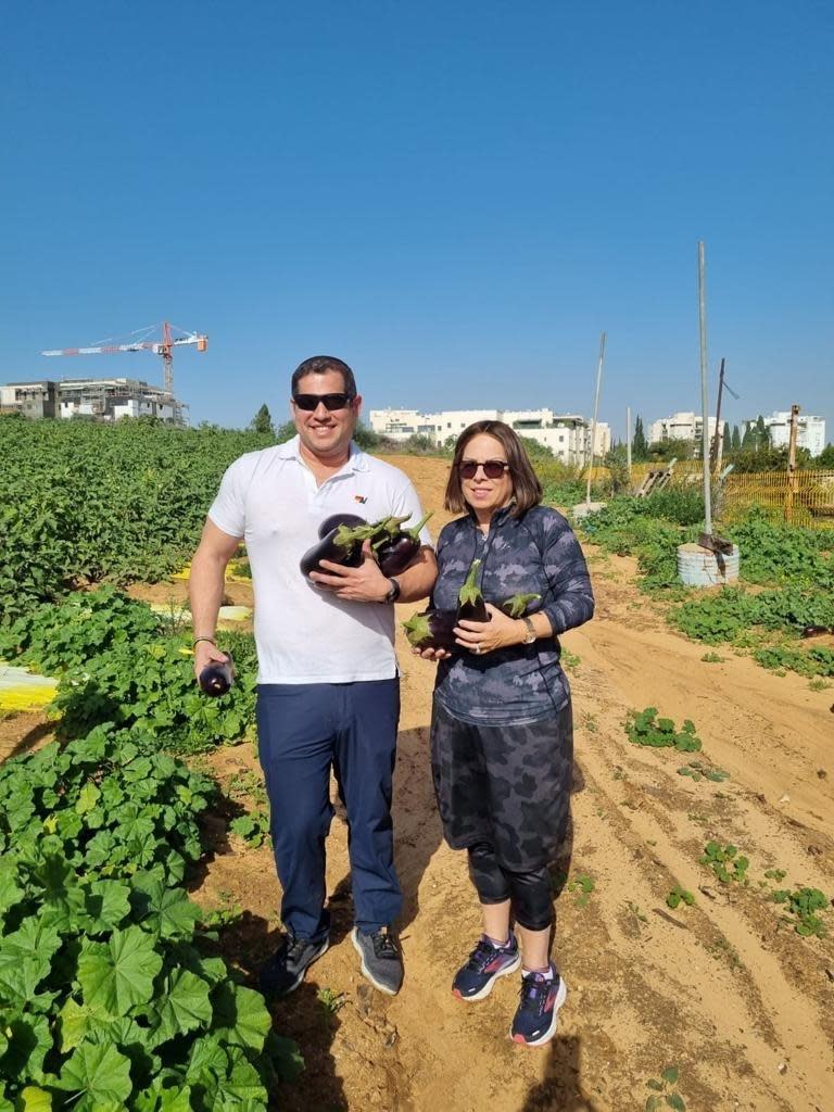 Deborah Chames Cohen, and her son, pick eggplants as volunteers in Israel.  / Credit: courtesy Deborah Chames Cohen