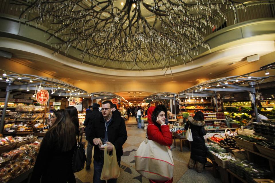 People buy groceries at the Grand Central Market at Grand Central Station in New York, February 2, 2013. Grand Central Terminal, the doyenne of American train stations, is celebrating its 100th birthday. Opened on February 2, 1913, the iconic New York landmark with its Beaux-Arts facade is an architectural gem, and still one of America's greatest transportation hubs. (REUTERS/Eduardo Munoz)