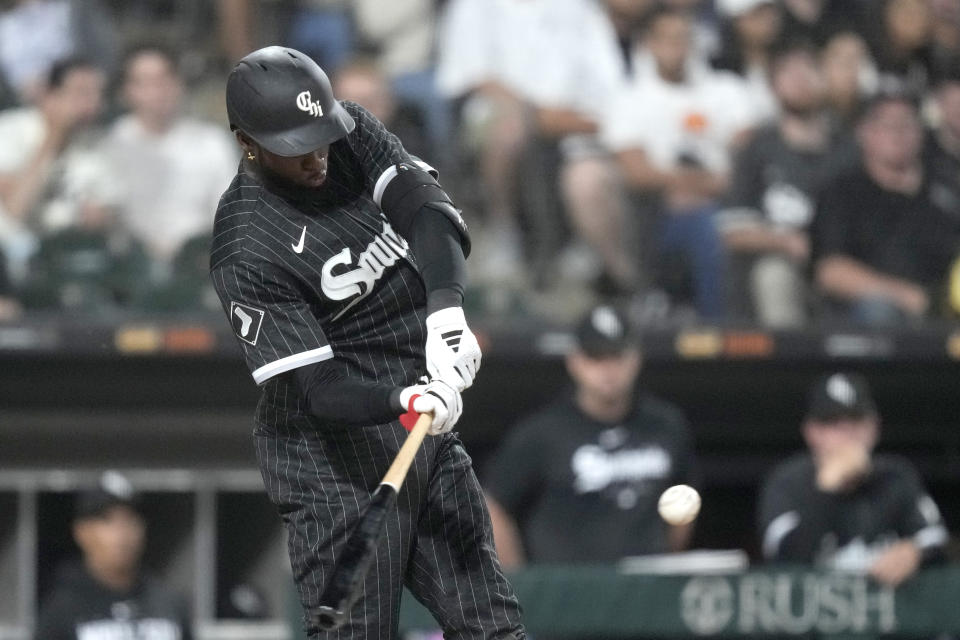 Chicago White Sox's Luis Robert Jr. hits a single off Miami Marlins relief pitcher Dylan Floro to drive in the winning run during the ninth inning of a baseball game Friday, June 9, 2023, in Chicago. The Chicago White Sox won 2-1. (AP Photo/Charles Rex Arbogast)
