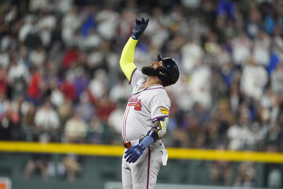 Atlanta Braves' Marcell Ozuna gestures after reaching second base on a double off Colorado Rockies relief pitcher Angel Chivilli in the seventh inning of a baseball game Saturday, Aug. 10, 2024, in Denver. (AP Photo/David Zalubowski)