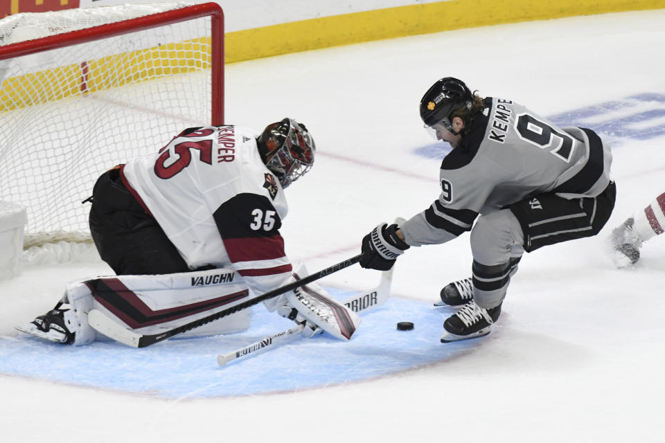 Arizona Coyotes goalie Darcy Kuemper blocks a shot by right wing Adrian Kempe during the first period of an NHL hockey game, Saturday, April 24, 2021, in Los Angeles. (AP Photo/Michael Owen Baker)