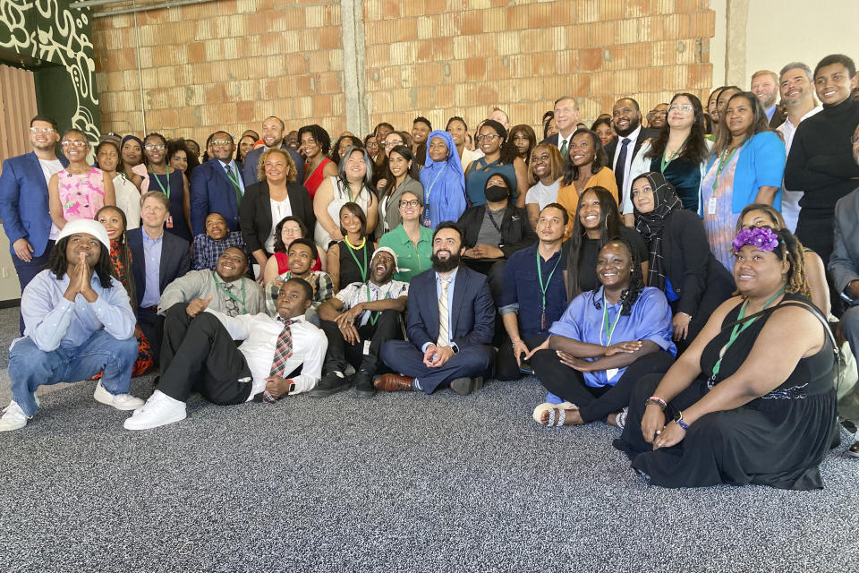 Graduates from the first cohort of the Detroit Apple Developer Academy pose for a photo following a ceremony held Thursday, June 30, 2022, in Detroit. The inaugural class of the Detroit Apple Developer Academy, a free program that teaches students the fundamentals of coding, design, marketing and project management, celebrated its unique accomplishment during a ceremony held Thursday. (AP Photo/Mike Householder)