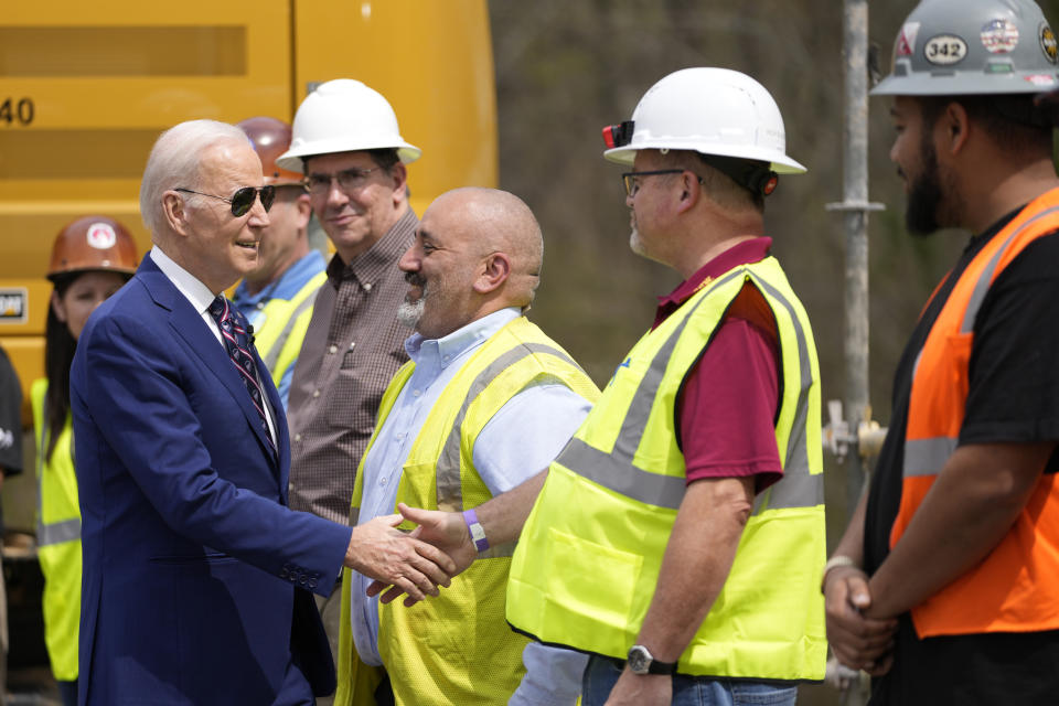 FILE - President Joe Biden greets people as he tours semiconductor manufacturer Wolfspeed Inc., in Durham, N.C., Tuesday, March 28, 2023. (AP Photo/Carolyn Kaster, File)