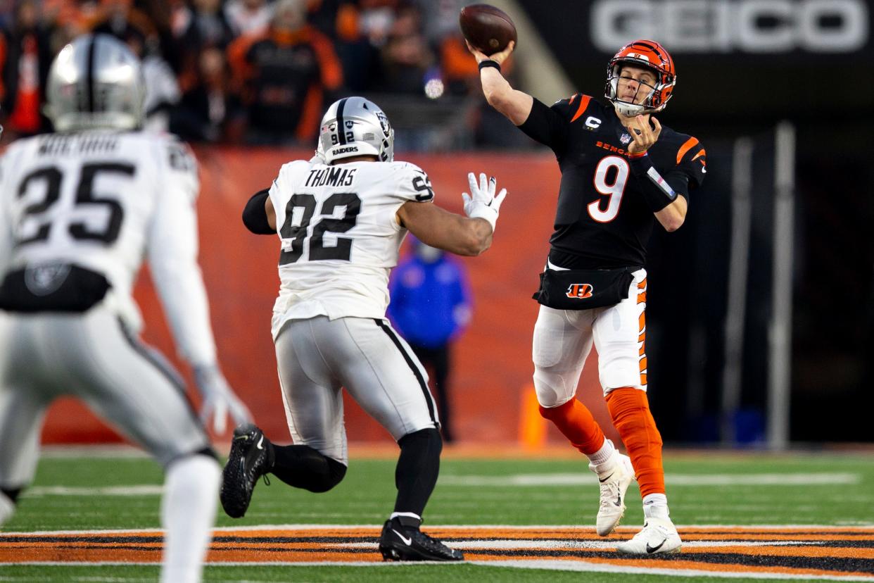 Cincinnati Bengals quarterback Joe Burrow (9) throws an incomplete pass as Las Vegas Raiders defensive end Solomon Thomas (92) pressures him in the first half the AFC wild card game between the Cincinnati Bengals and the Las Vegas Raiders on Saturday, Jan. 15, 2022, at Paul Brown Stadium in Cincinnati. 