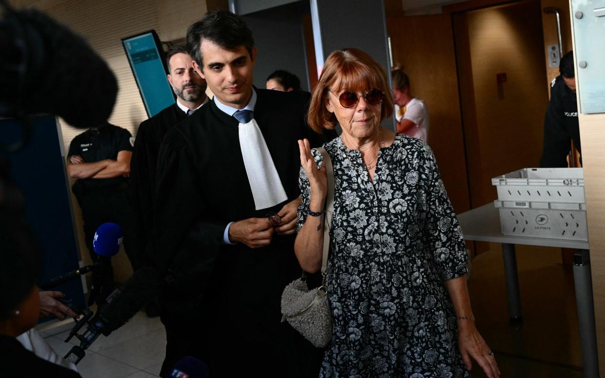 Gisele Pelicot is flanked by her lawyers Stephane Babonneau and Antoine Camus, walks during a break in the trial