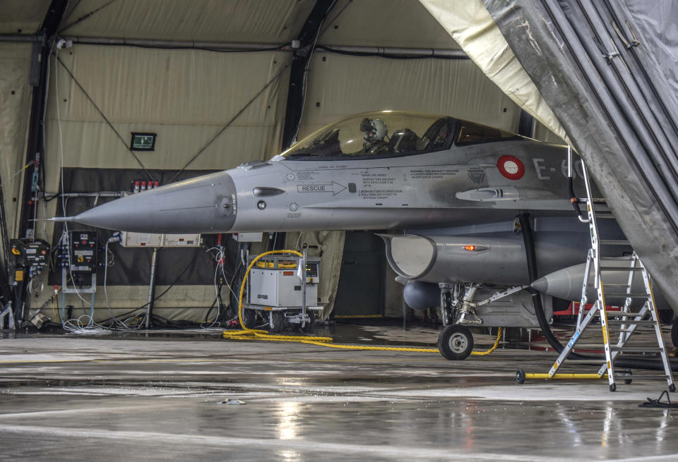 In this photo provided by Lithuanian Ministry of National Defense, a Danish Royal Air Force F-16 fighter jet stand on the tarmac after landing at the Siauliai airbase, some 230 km (144 miles) east of the capital Vilnius, Lithuania, Thursday, Jan. 27, 2022. As tensions build with Russia, NATO is focused on defending its 30 member countries. The world's biggest military organization doesn't do sanctions; it does security. That means deterring any attempt to destabilize members on its eastern flank like Estonia, Latvia, Lithuania and Poland. NATO stands ready to beef up its defenses there should Russia invade Ukraine. (Lithuanian Ministry of National Defense via AP)