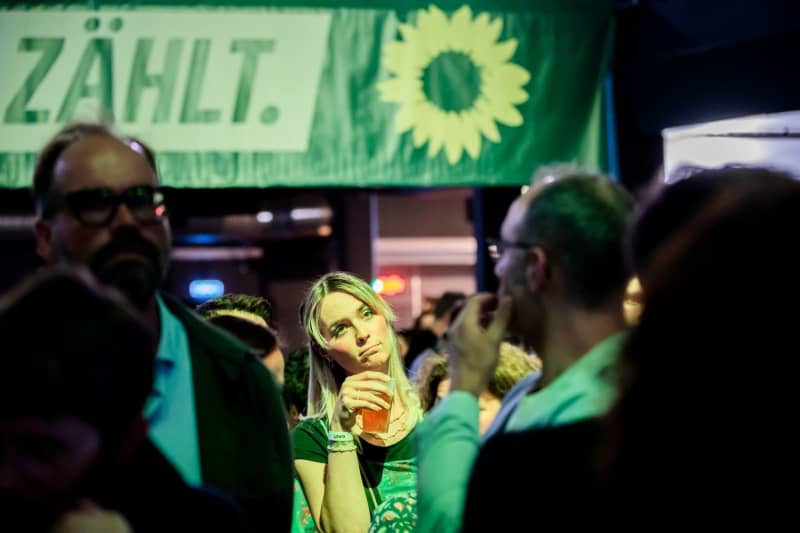 A woman stands at the Green Party's election party in the Columbiahalle during the announcement of the first forecasts for the results of the 2024 European elections. Christoph Soeder/dpa