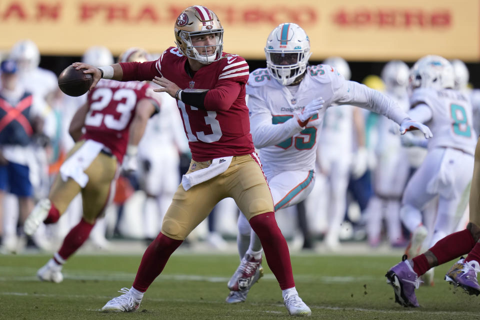 San Francisco 49ers quarterback Brock Purdy (13) passes as Miami Dolphins linebacker Jerome Baker (55) applies pressure during the first half of an NFL football game in Santa Clara, Calif., Sunday, Dec. 4, 2022. (AP Photo/Godofredo A. Vásquez)