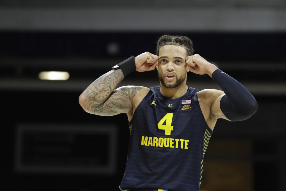 Marquette's Theo John (4) looks at the scoreboard after Marquette missed a shot during overtime of an NCAA college basketball game against Butler, Friday, Jan. 24, 2020, in Indianapolis. Butler won 89-85. (AP Photo/Darron Cummings)