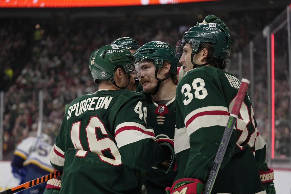 Minnesota Wild center Sam Steel, center, celebrates with teammates after scoring during the first period of an NHL hockey game against the St. Louis Blues, Saturday, April 8, 2023, in St. Paul, Minn. (AP Photo/Abbie Parr)