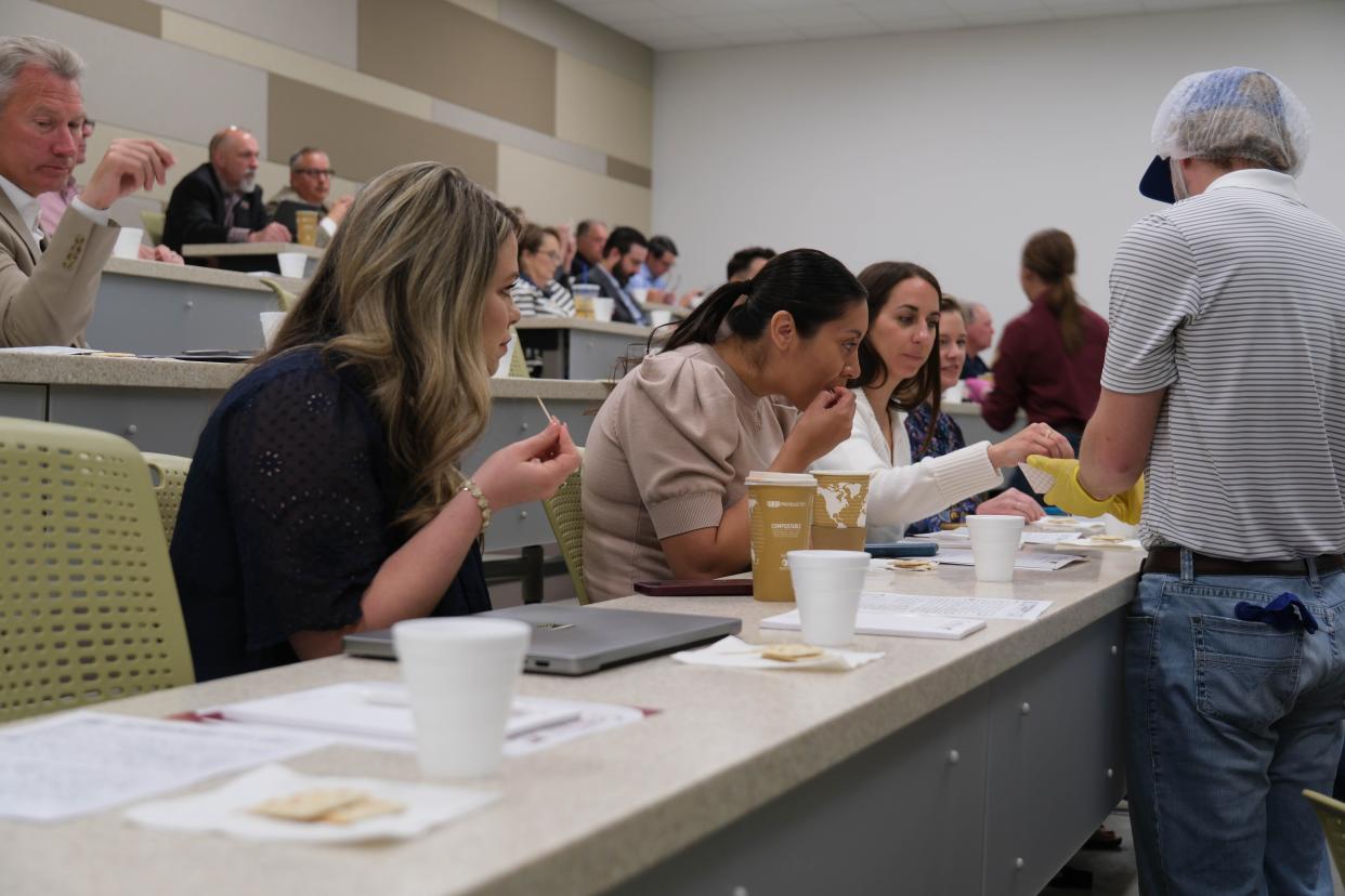 Attendees sample a cut of beef Tuesday at a One West Campaign Steering Committee Meeting at West Texas A&M.
