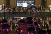 People visit at Apple Store in Beijing on Saturday, Dec. 23, 2023. It was tumultuous 2023 for the Chinese economy. Some of the world's biggest brands said they were weighing, or already have decided, to shift manufacturing away from China amid unease about security controls, government protection of their Chinese rivals and Beijing's wobbly relations with Washington. But there was at least one bright spot for Beijing amid all the tough news about declining foreign investment: American fast food companies have announced a surge of investment in a market of 1.4 billion people. KFC, McDonald's and Starbucks are among companies in recent months that have announced plans for major investment in China. (AP Photo/Andy Wong)