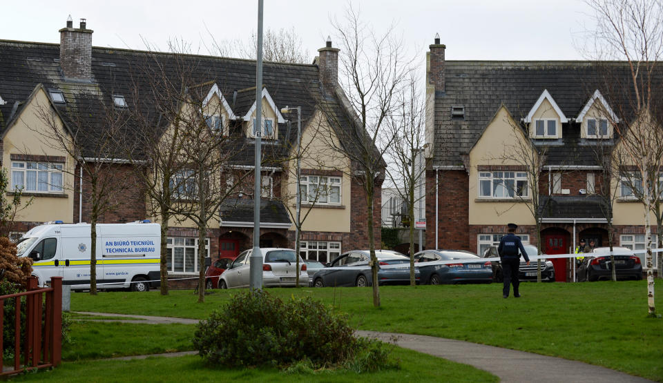 A police officer and police tape surround a house in Newcastle, Dublin, where the children were found.