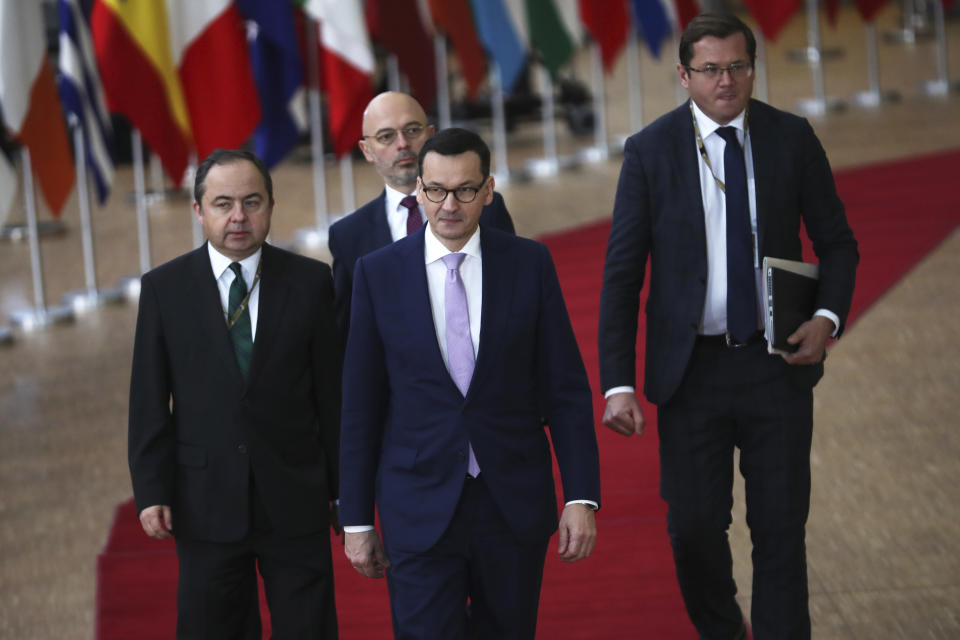 Polish Prime Minister Mateusz Morawiecki, center, arrives for an EU summit in Brussels, Friday, Dec. 13, 2019. European Union leaders are gathering Friday to discuss Britain's departure from the bloc amid some relief that Prime Minister Boris Johnson has secured an election majority that should allow him to push the Brexit deal through parliament. (AP Photo/Francisco Seco)