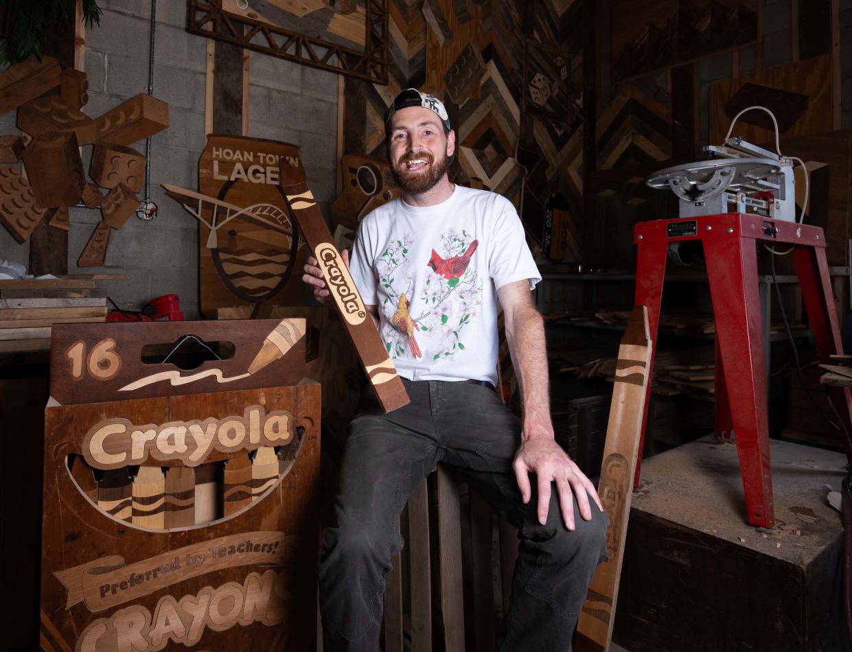 Wisconsin Wood Artist Ike Wynter, who uses discarded wood to make art that focuses on nostalgia and mental health awareness, showcases one his Crayola art pieces on Wednesday June 12, 2024 in Butler, Wis.