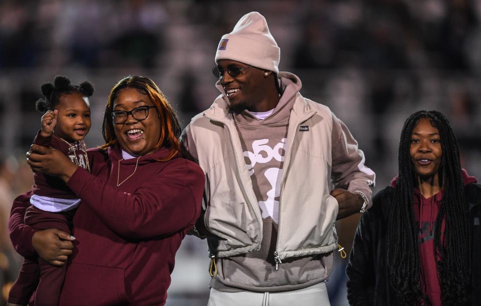 Cincinnati Bengals WR and Oak Ridge alum Tee Higgins, center, is inducted into the Oak Ridge Sports Hall of Fame on Blankenship Field. He's joined by his nephew LaRez Dendy, from left, sister Keke Stewart, and niece Ze'Yana Stewart. Not shown is Camilla Stewart, his mom