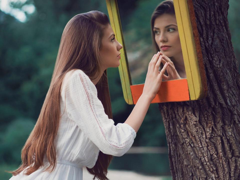 woman looking in mirror