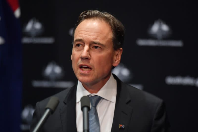 Pictured is Federal Health Minister Greg Hunt speaking to reporters during a press conference. 