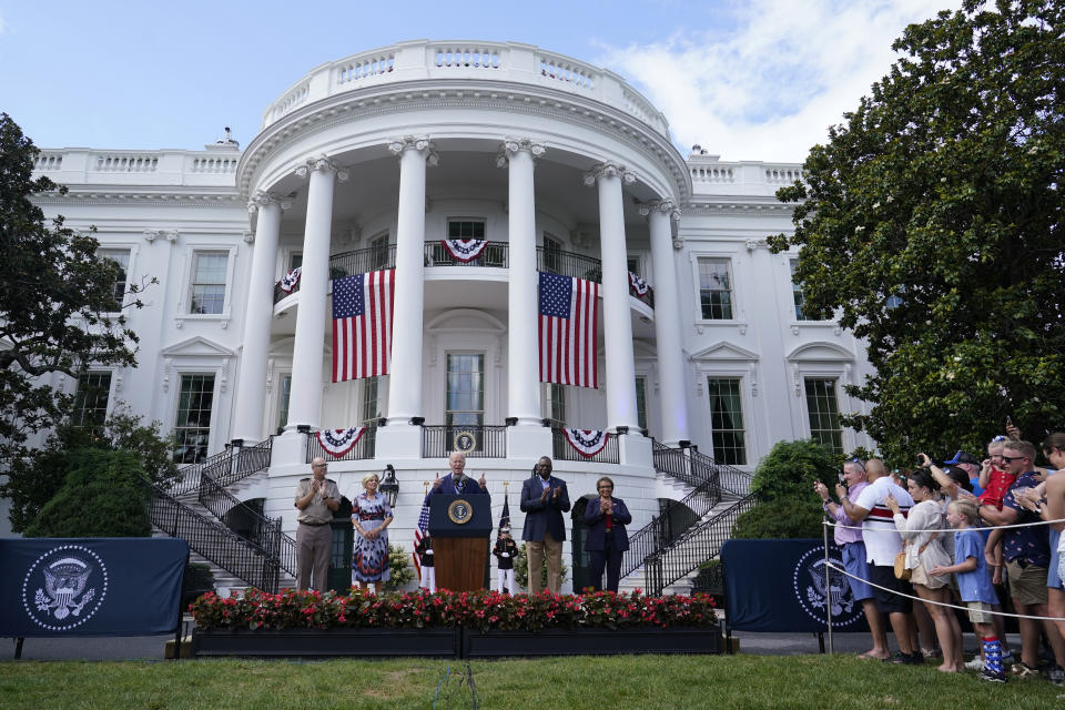 President Joe Biden, center, standing with, from right, Senior White House Military Office Chaplain Army Col. John Barkemeyer, first lady Jill Biden, Defense Secretary Lloyd Austin and his wife Charlene Austin, speaks on the South Lawn of the White House in Washington, Tuesday, July 4, 2023, during a barbecue with active-duty military families to celebrate the Fourth of July. (AP Photo/Susan Walsh)